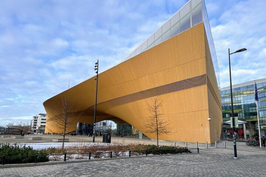 A modern building with a unique curved roof structure. 4