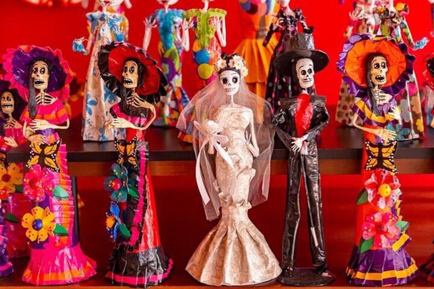 A collection of colorful skeleton figures in traditional attire. 2