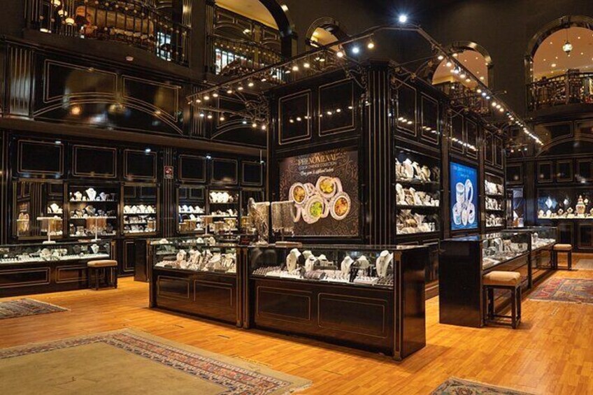 A luxury store with wooden display cases and ornate lighting. 4