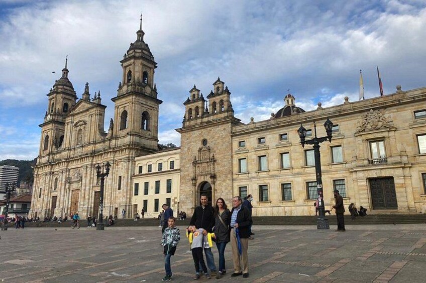 A historic building with multiple towers and a large open plaza. 2