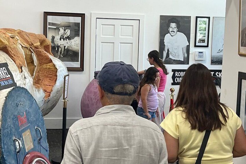 A group of people viewing art in a gallery. 3