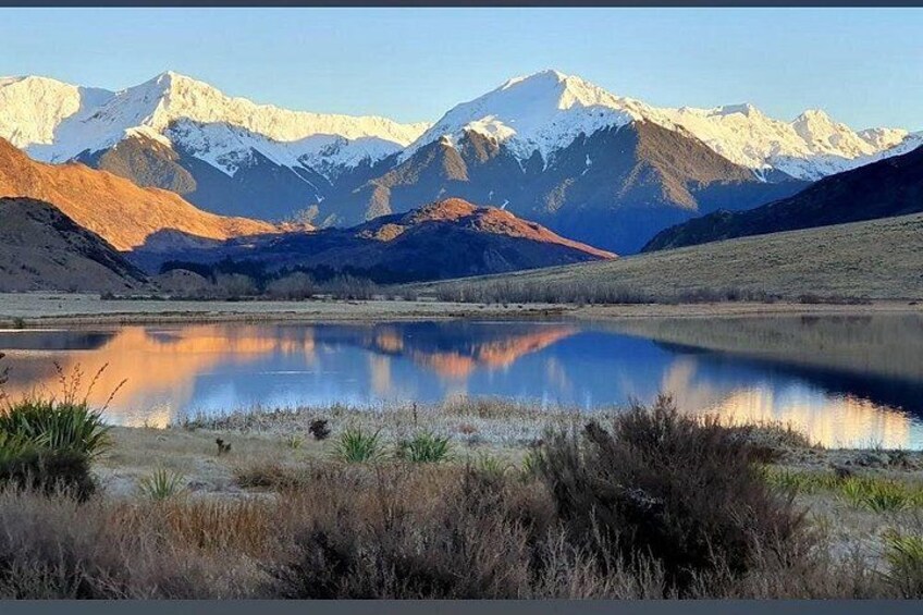 A mountain range, a lake, and a clear sky. 2