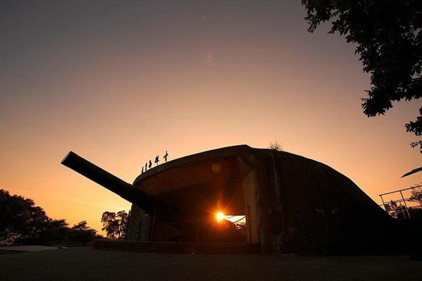 A large, curved building with a prominent entrance and a long, horizontal structure extending from it. 2