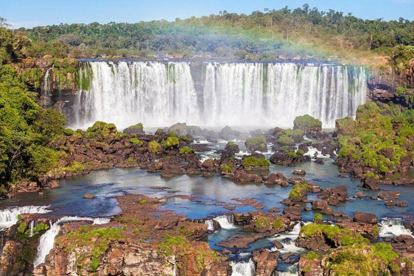 A large waterfall with multiple cascades surrounded by rocky terrain and greenery. 2