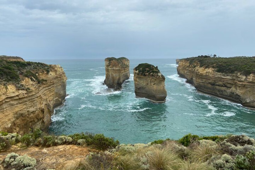 A coastal landscape with prominent rock formations and a rugged coastline. 5