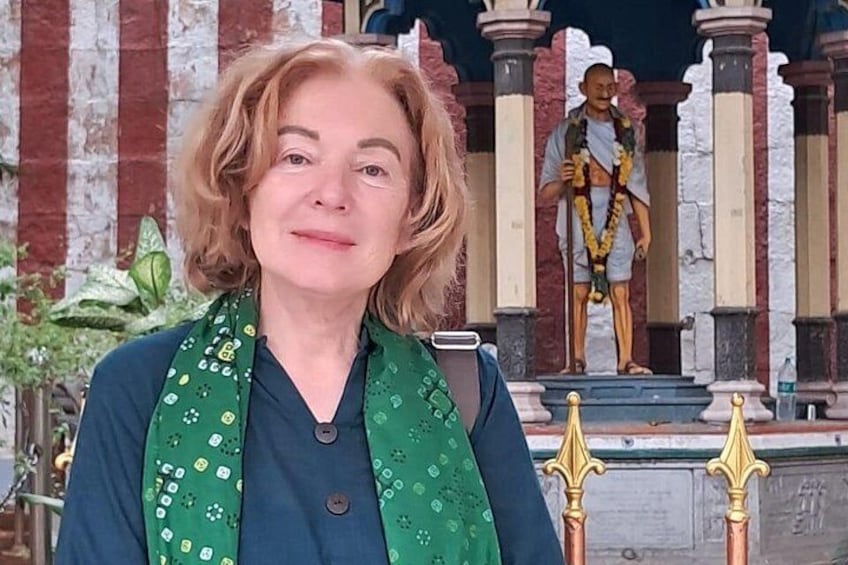A person standing in front of a temple with a statue. 2