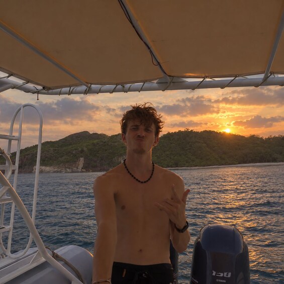 A person on a boat with a sunset in the background. 4