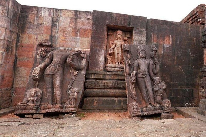 Ancient stone carvings of deities and a doorway. 5