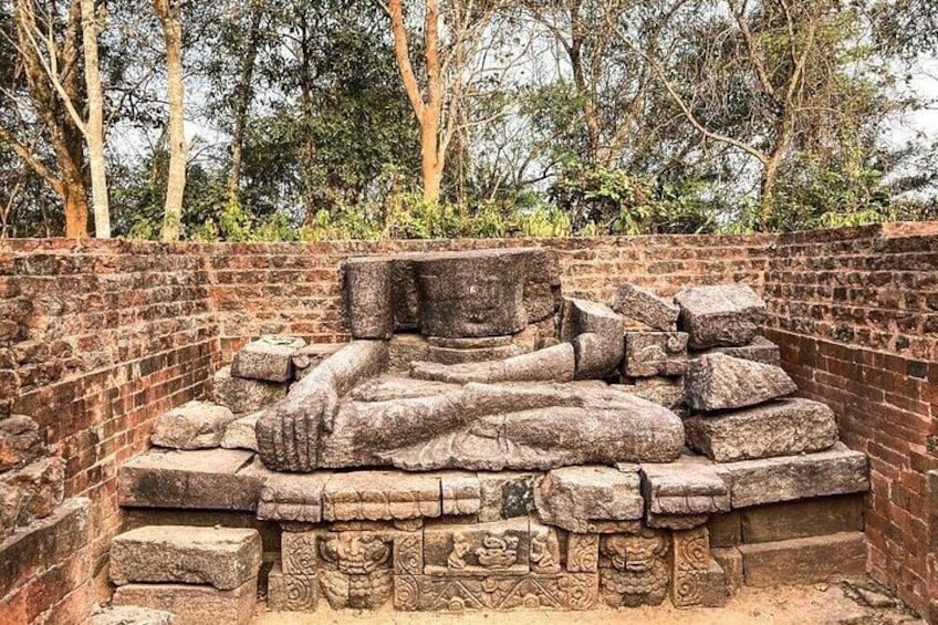 Ancient stone carvings and a brick wall. 2