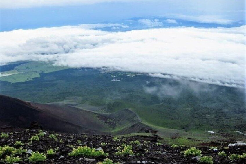 A mountainous landscape with green valleys and a cloud-covered sky. 2