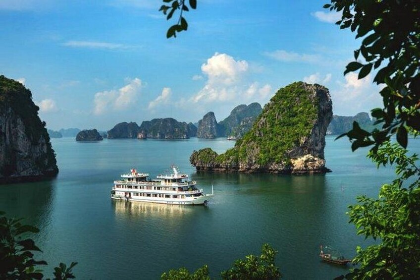 A boat on calm waters surrounded by green islands. 3