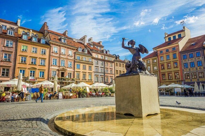 A square with a statue, cobblestone pavement, and historic buildings. 3