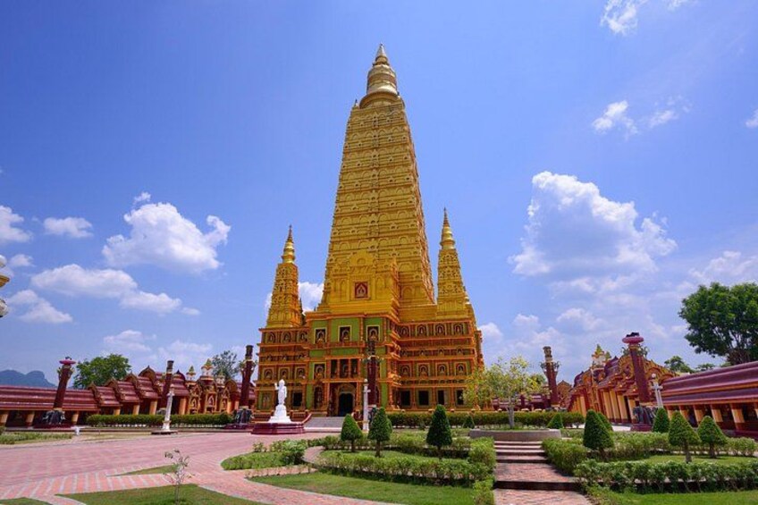 A large, golden temple with multiple spires, surrounded by well-maintained gardens and pathways. 2