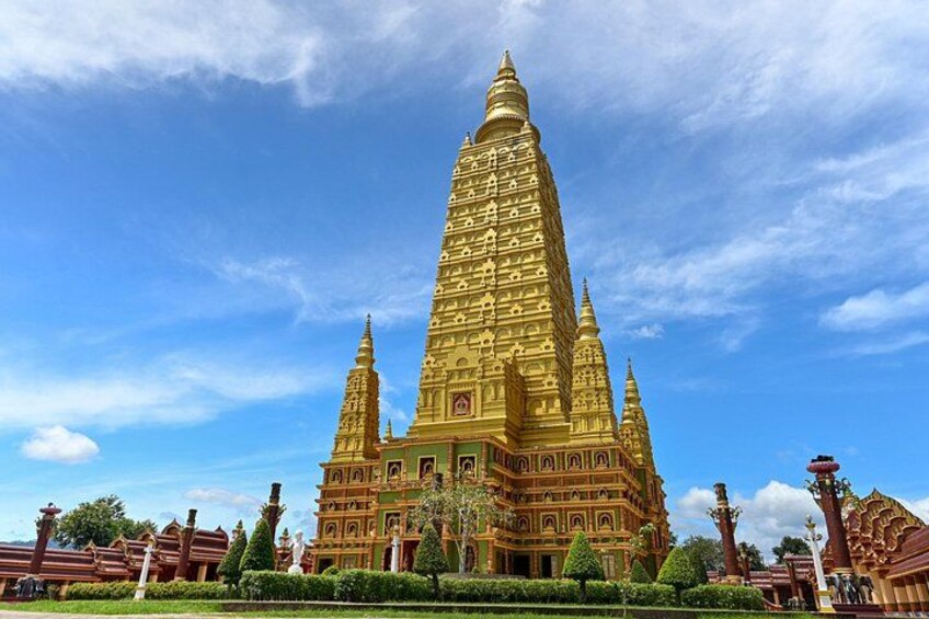 A large, golden temple with multiple spires, surrounded by well-maintained gardens and smaller structures. 3
