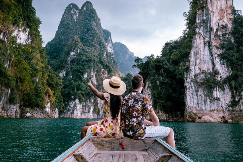 A boat on a river with cliffs in the background. 1