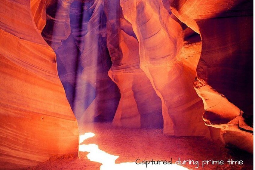 A canyon with layered rock formations and a narrow passageway. 3