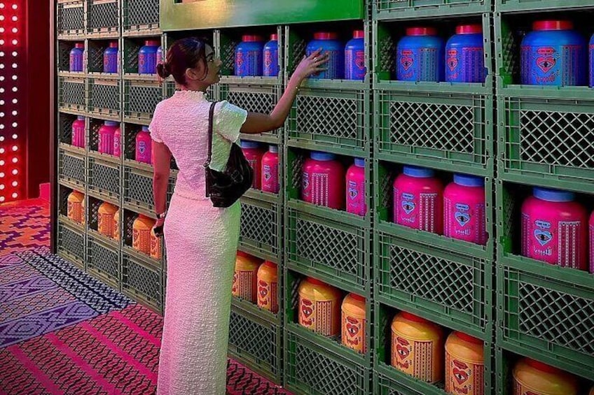 A person in a white dress browsing shelves stocked with colorful containers. 3