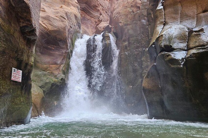 A waterfall cascading down a rocky cliff into a river. 4