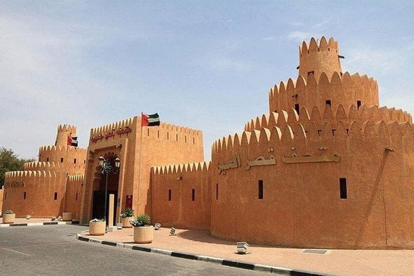 A large, fortress-like building with multiple towers and a central entrance. 2