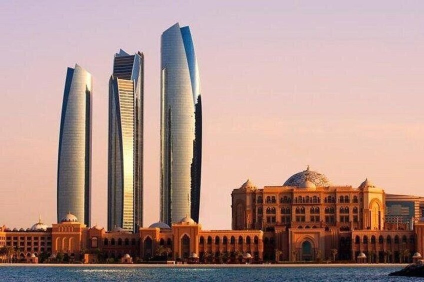 Three modern skyscrapers, a historic building, and a body of water. 2