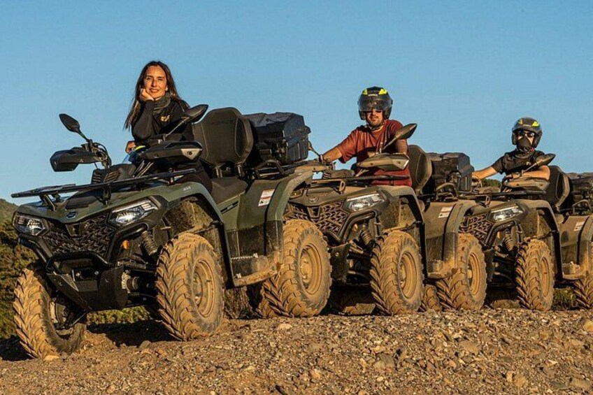 Four off-road vehicles parked on a rocky terrain. 2