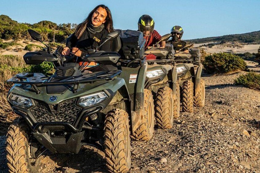 A group of off-road vehicles on a rocky terrain with sparse vegetation. 3
