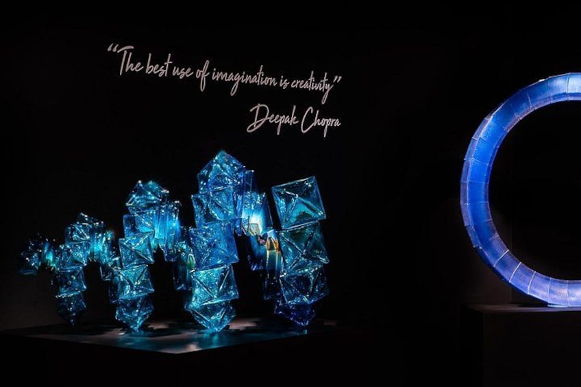 A sculpture of blue crystals with a quote by Deepak Chopra. 1