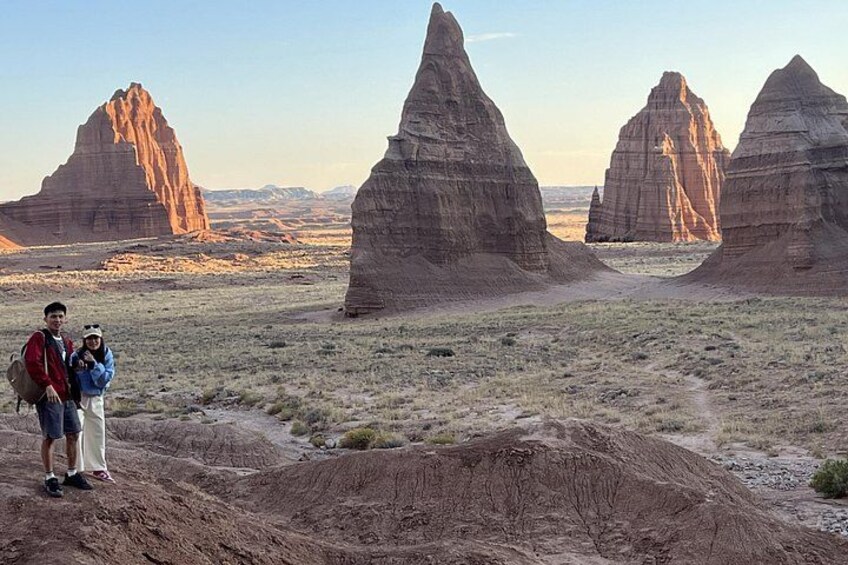 A desert landscape with prominent rock formations and a dirt path. 1