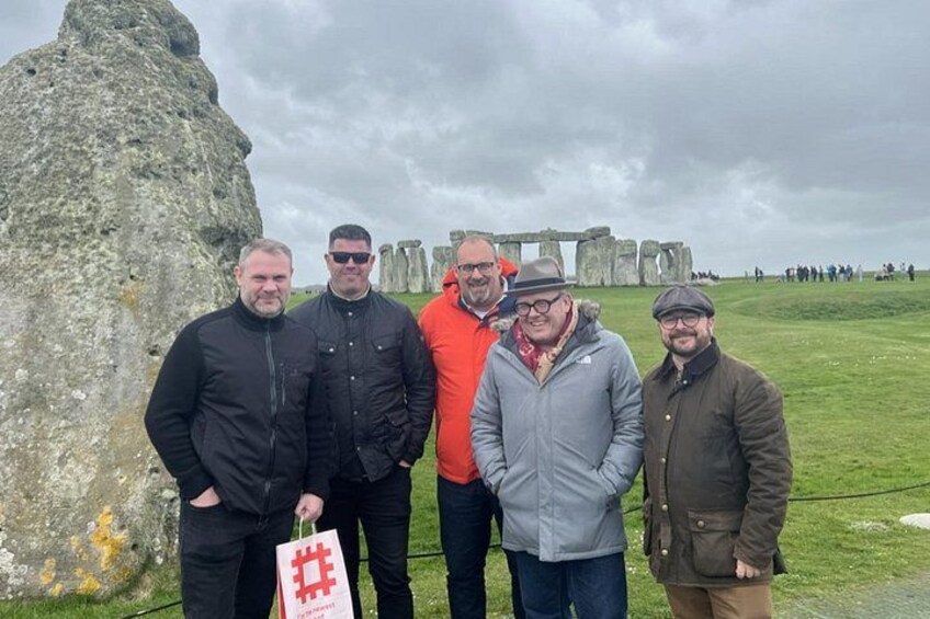 Een groep mensen staat voor Stonehenge. 5