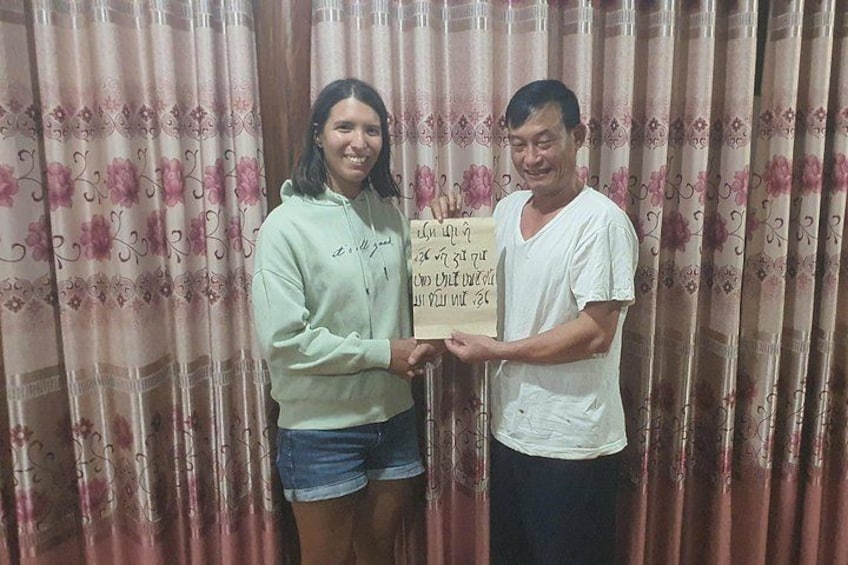 Two people holding a sign with text. 4