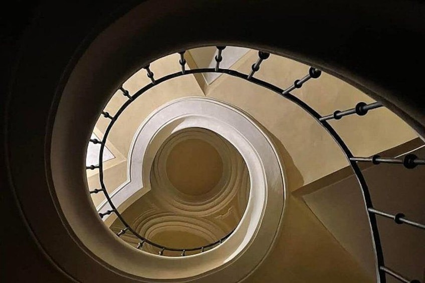 A spiral staircase with a metal railing and a circular design. 3