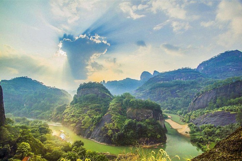 A river winding through a mountainous landscape with lush greenery and rocky cliffs. 2