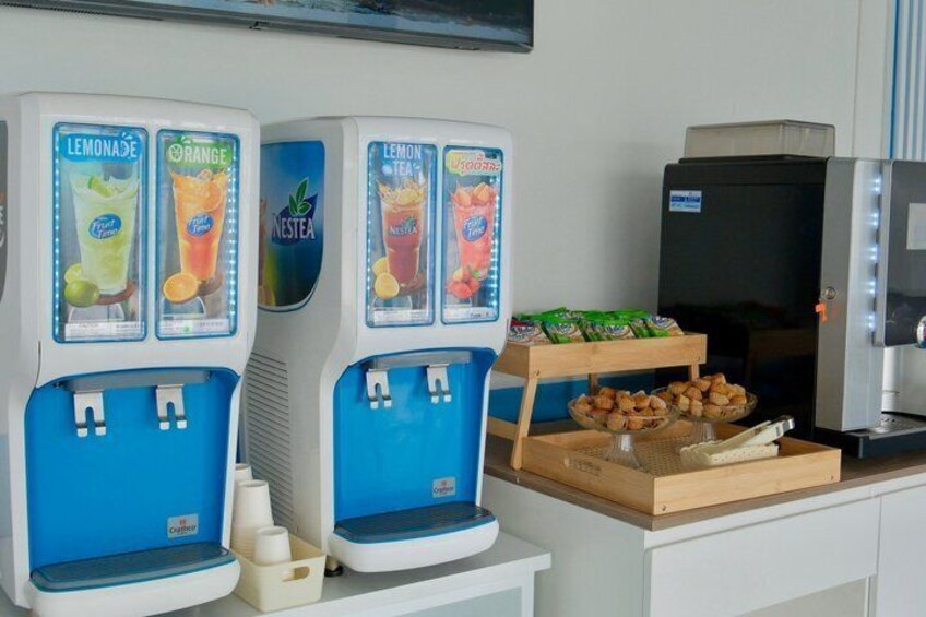 Two beverage dispensers, a refrigerator, and a tray of snacks. 3