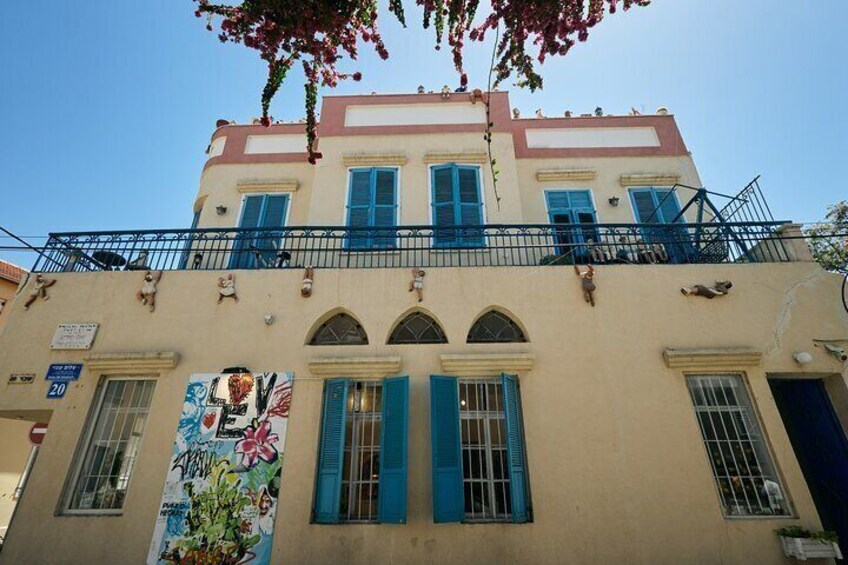 A building with blue shutters and a balcony. 1