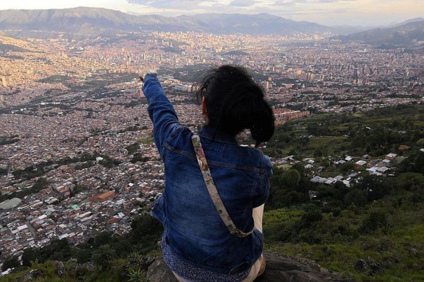 A person overlooking a cityscape from a high vantage point. 1