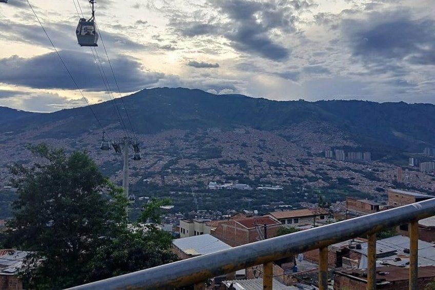 A cable car system, a cityscape with buildings, and a mountain in the background. 5