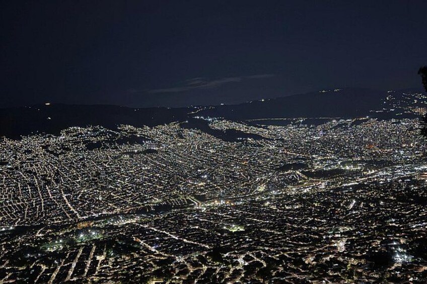 A cityscape at night with illuminated streets and buildings. 3
