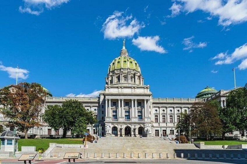 A large government building with a prominent dome and a grand staircase leading to the entrance. 3