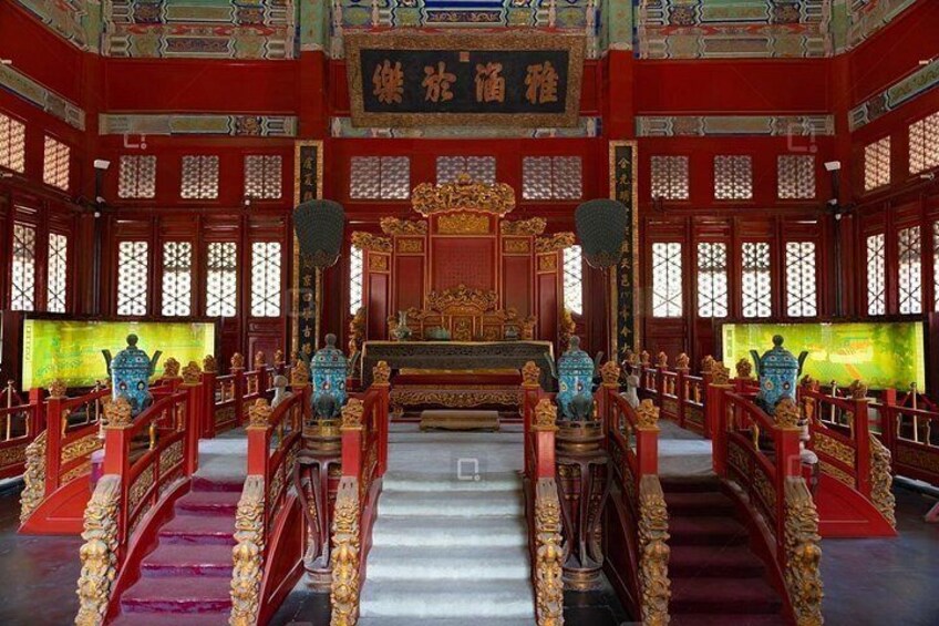 A traditional Chinese temple interior with red and gold decorations, a central altar, and a staircase leading to the main hall. 2