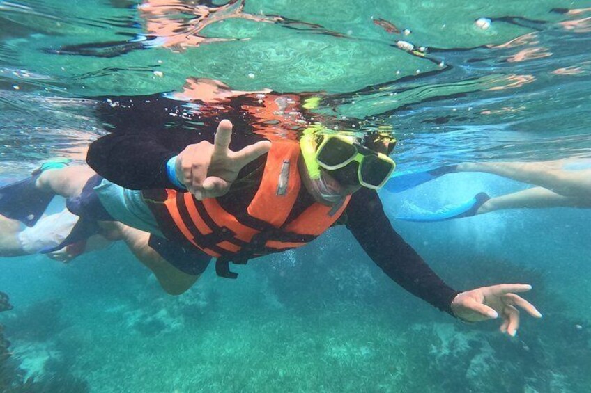 A person underwater, wearing a snorkel and fins, with a life jacket. 5