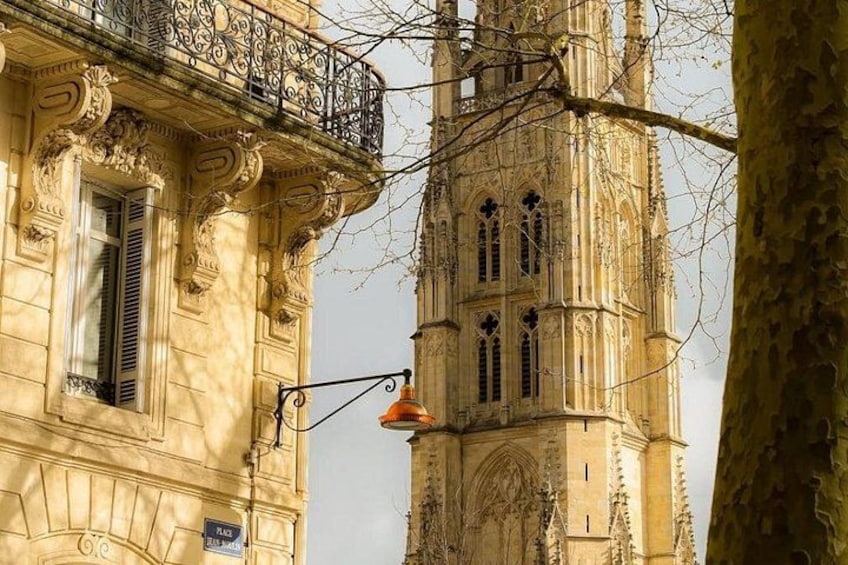 A historic building with ornate balconies and a tall tower. 4