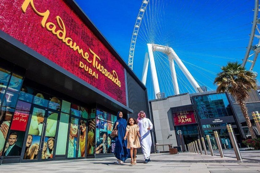 A building with a red facade and the name 'Madame Tussauds Dubai' on it. 5