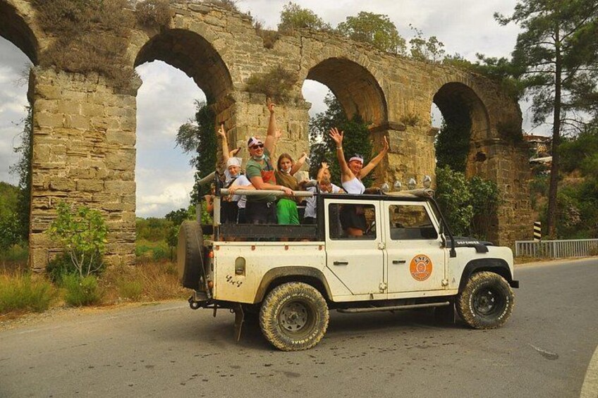 A white off-road vehicle with passengers enjoying a ride. 3