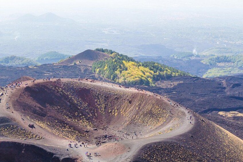 A large crater with people walking around it. 1