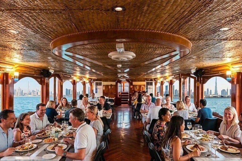 A dining area on a boat with tables and people eating. 5