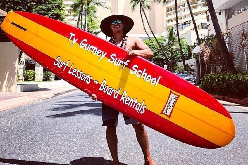 A person holding a surfboard with text on it. 2