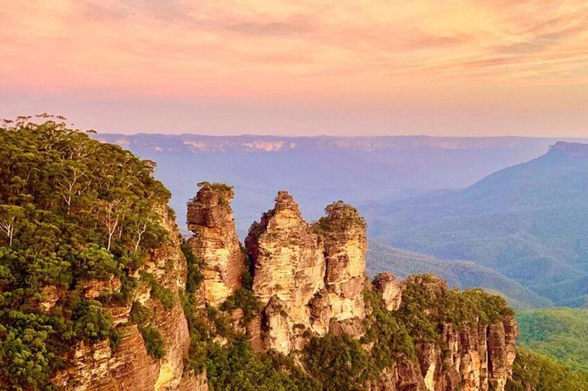 A landscape with prominent rock formations and a forested area. 1