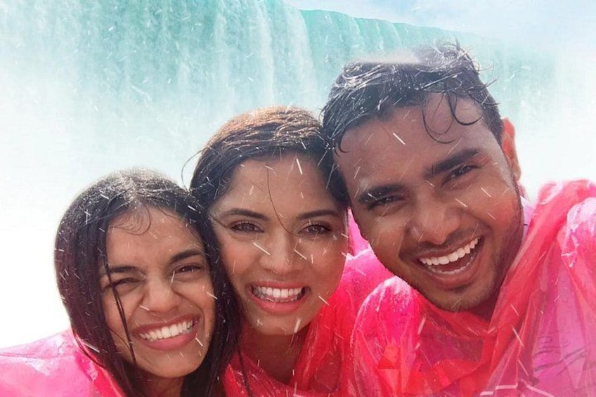Three people in a pink raincoat. 3