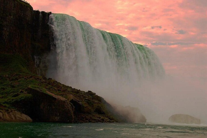 A large waterfall cascading down a cliff into a body of water. 5
