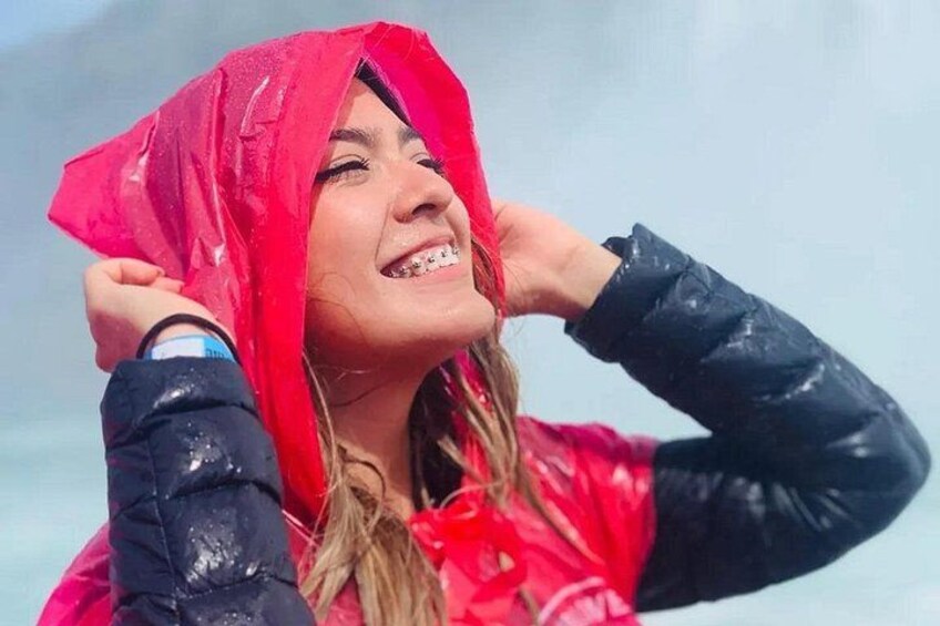A person wearing a red hooded jacket and black gloves. 2